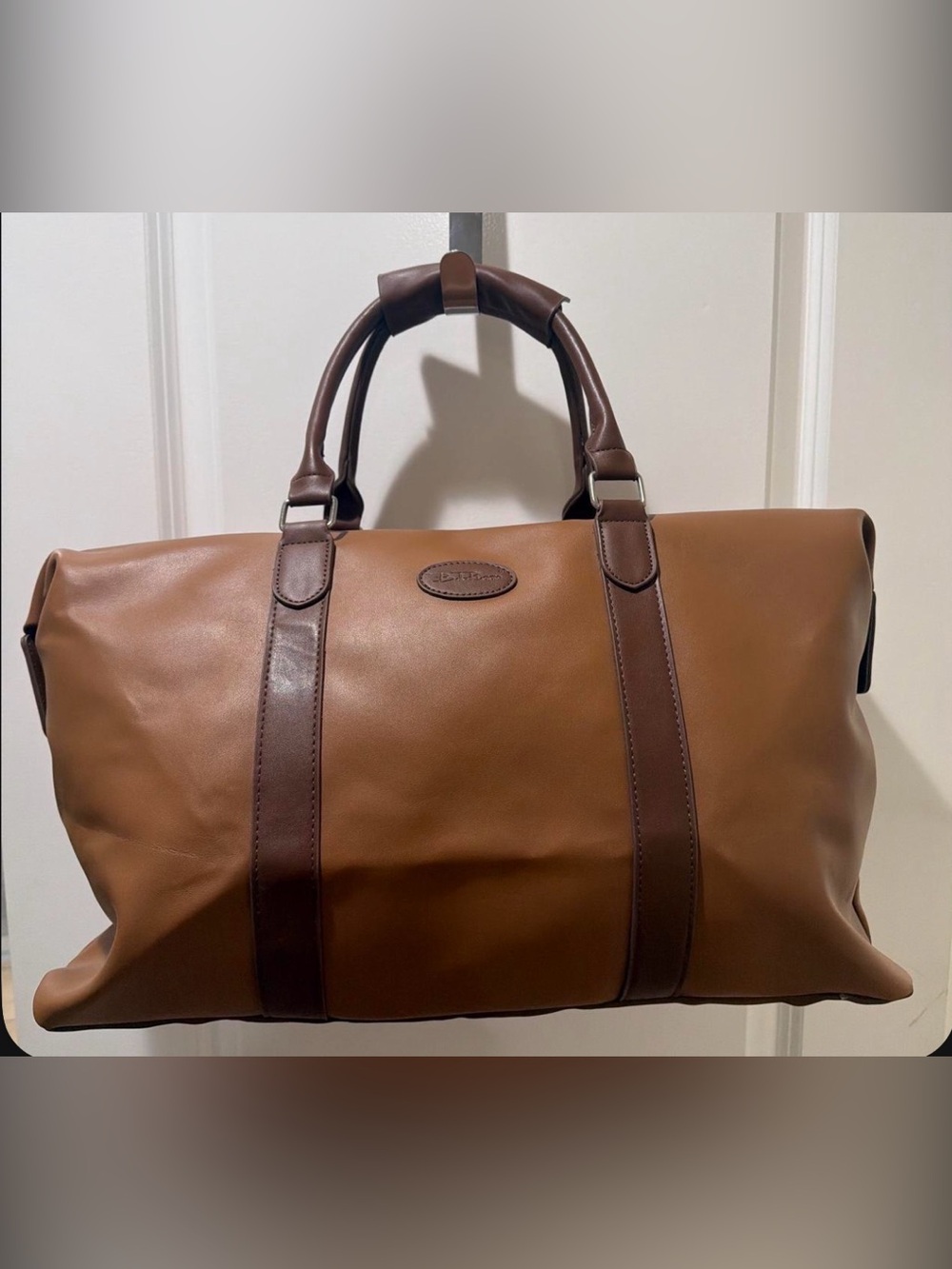 Brown weekender bag with side snap closures